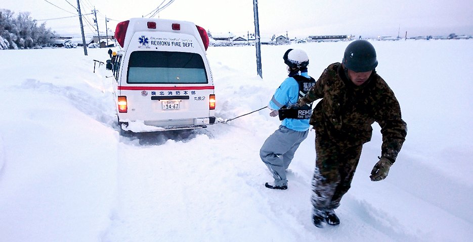 記録的大雪で立ち往生した救急車を引っ張る陸上自衛隊員（8日午前、福井市　陸自第10師団提供＝時事）