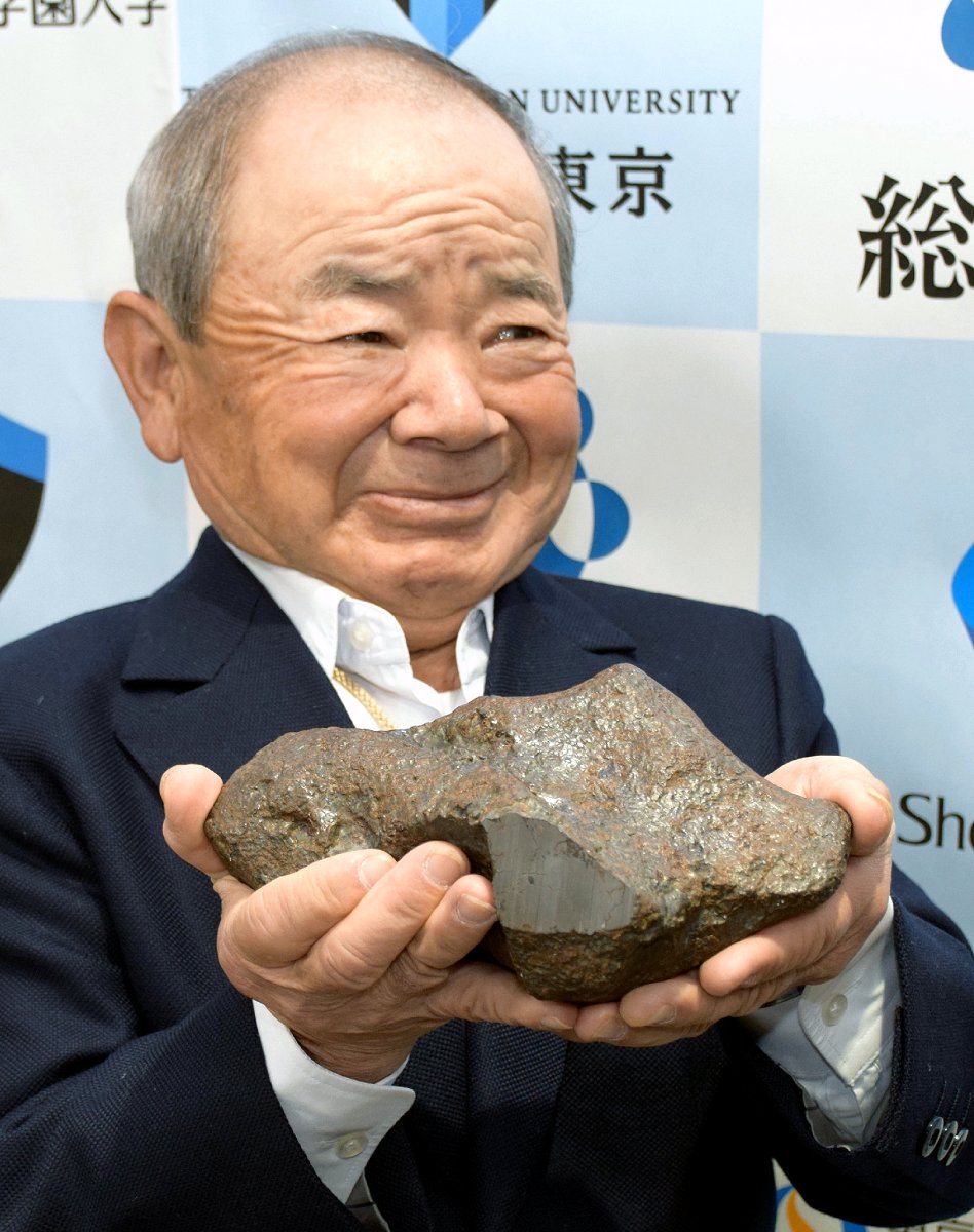 「長良隕石」と命名された隕石を持つ発見者の三津村勝征さん（1日午後、時事）